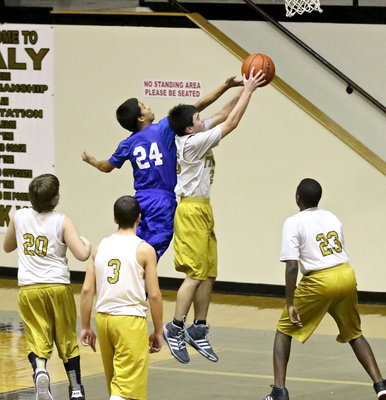 Image: Kyle Tindol(25) shows skill in capturing a rebound.
