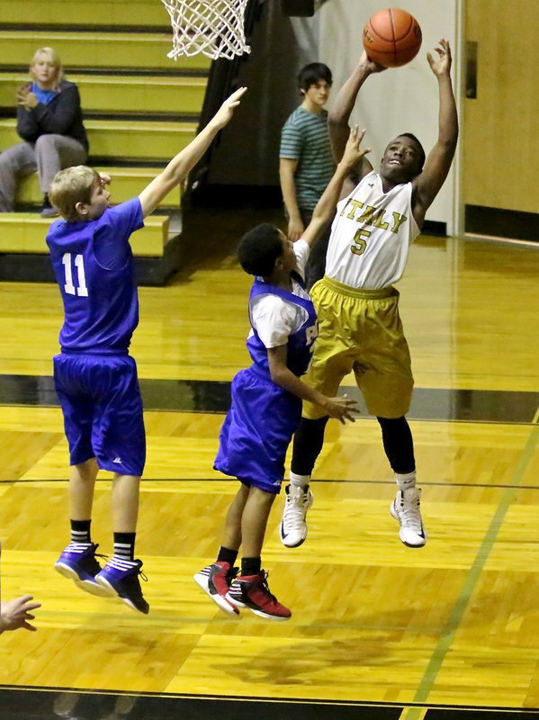 Image: Kendrick Norwood(5) tries a baseline shot.