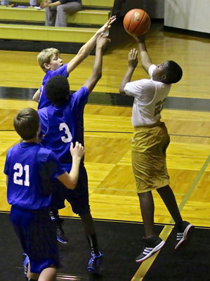 Image: Anthony Lusk, Jr.(23) attempts a reverse layup late in the 8th grade game.