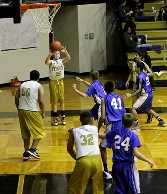 Image: Cade Brewer(15) tries his hand from 3-point range.