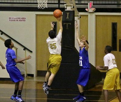 Image: Kyle Tindol(25) twists and scores under the basket for the Italy 8th graders.