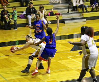 Image: Kortnei Johnson(3) saves the ball into Jaclynn Lewis(13), who then bounce passes over to teammate Cory Chance(40), who scores the basket.