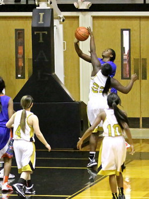 Image: Lady Gladiator, Taleyia Wilson(22) clamps down on a Lady Gator shooter.