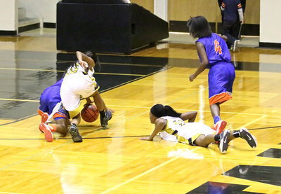 Image: Victory earned: Lady Gladiators, Kendra Copeland(10) and K’Breona Davis(12) relentlessly fight for their teammates.