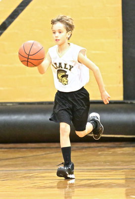 Image: Chase Hyles(11) skillfully dribbles the ball on the fly for his IYAA 3rd/4th grade boys team.