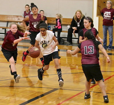 Image: Andrea Galvan(4) dribbles thru four Hillsboro defenders on her way to the basket.