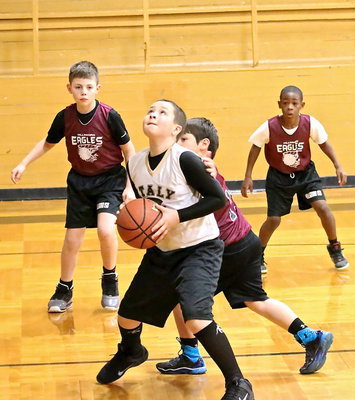 Image: Jayden Saxon(13) scores from under the basket.