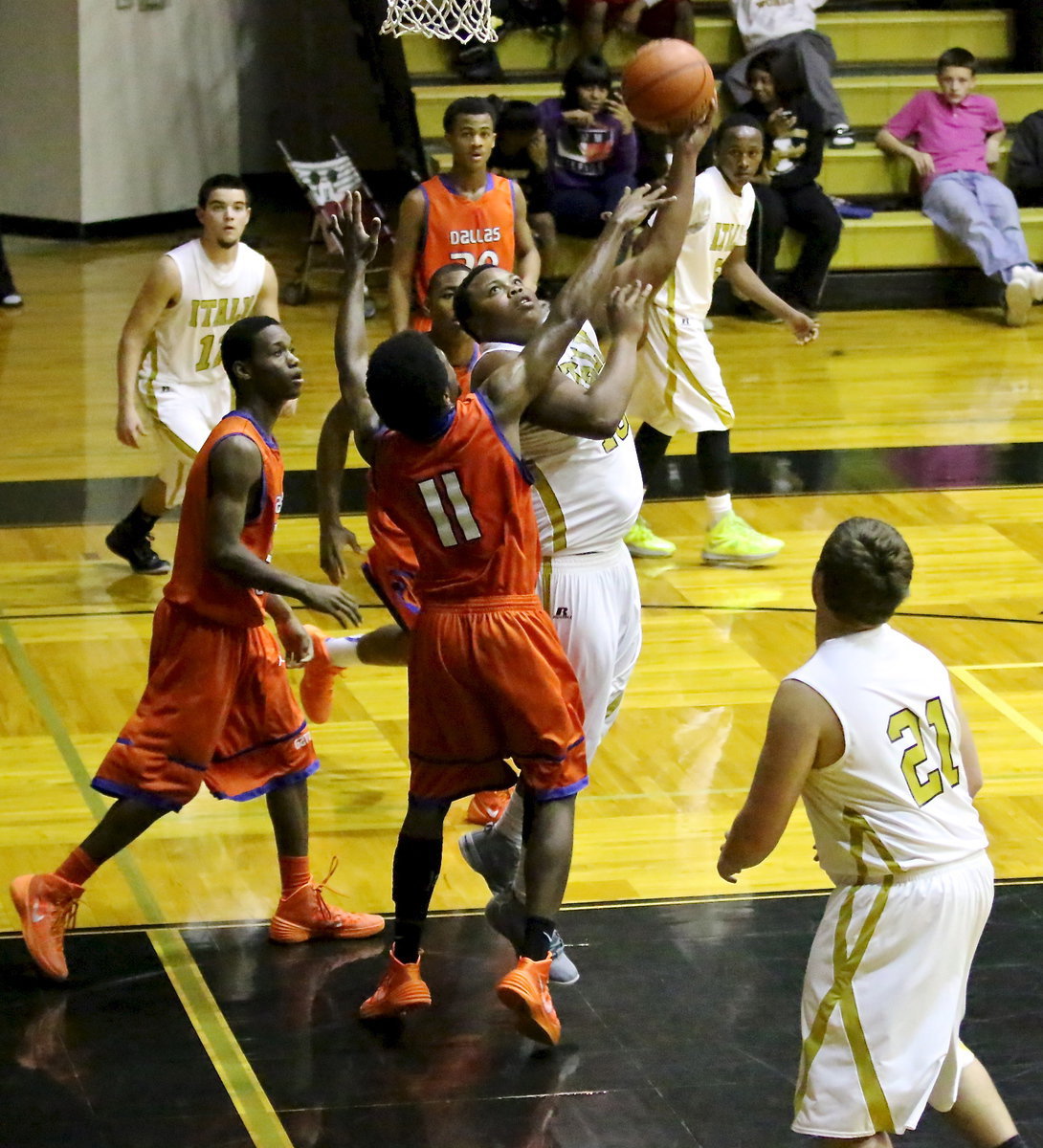 Image: Darol Mayberry(13) maneuvers under the basket to flip up a shot for the Gladiators. Italy was playing an uphill battle against Dallas Gateway who won the matchup, 89-54, to take control of the district’s top spot.