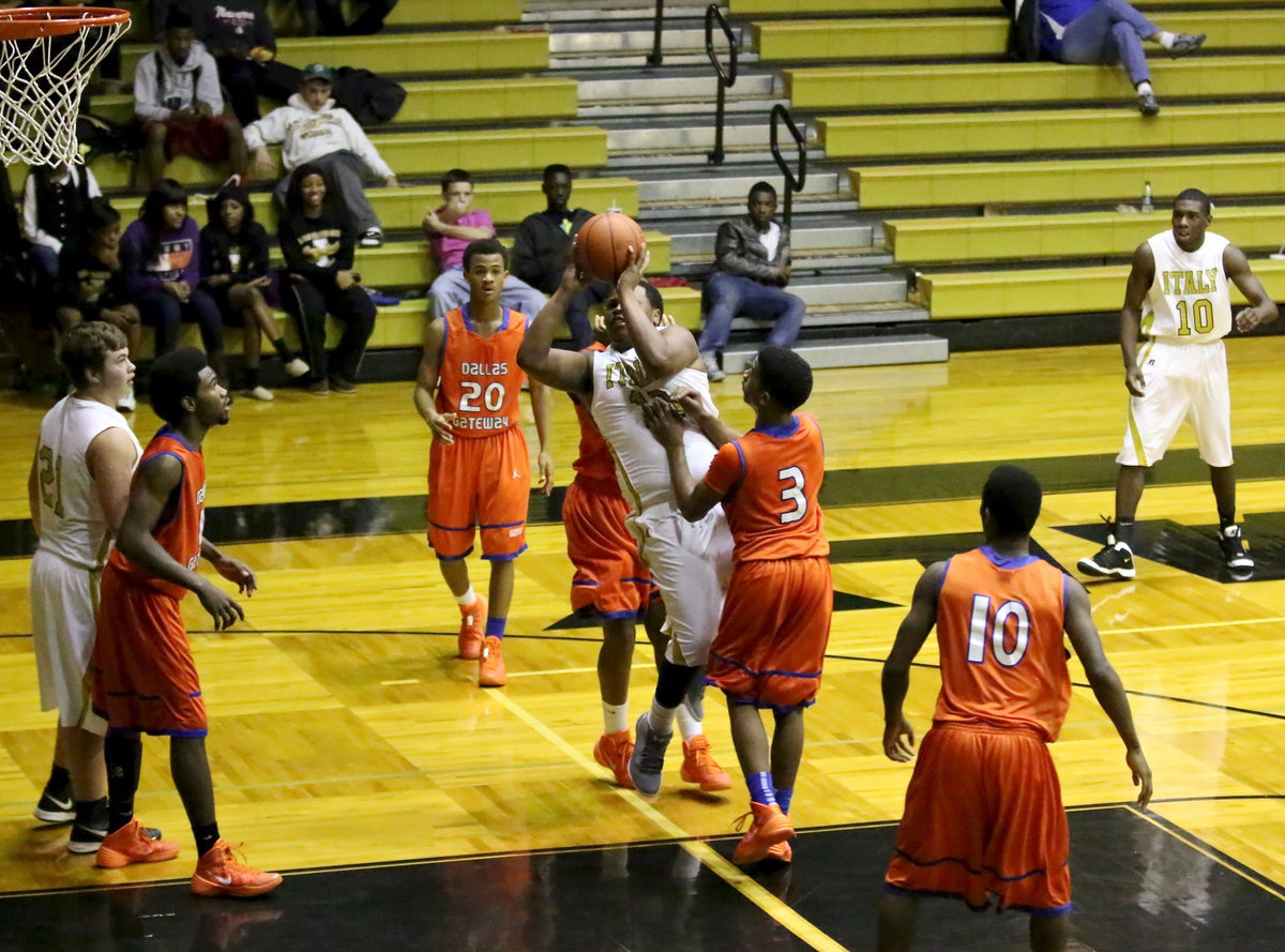 Image: Darol Mayberry(13) slices his way into the lane to put up a shot and draw a foul. The senior made both freebies from the stripe.