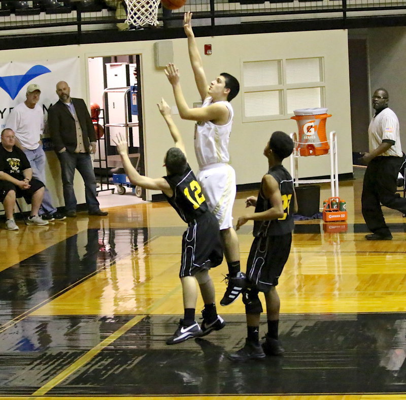 Image: Mason Womack(10) scores easily over a pair of JV Wampus Cat defenders.