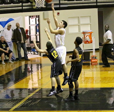 Image: Mason Womack(10) scores easily over a pair of JV Wampus Cat defenders.