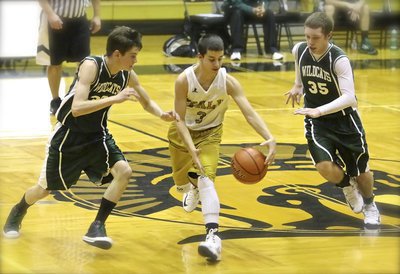 Image: Italy 8th grader, Gary Escamilla(3) dribbles away from trouble with a pair of Wildcats on his tail.