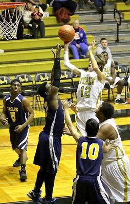 Image: Ty Windham(12) gets to the front of the rim for the Gladiators to put up a shot.