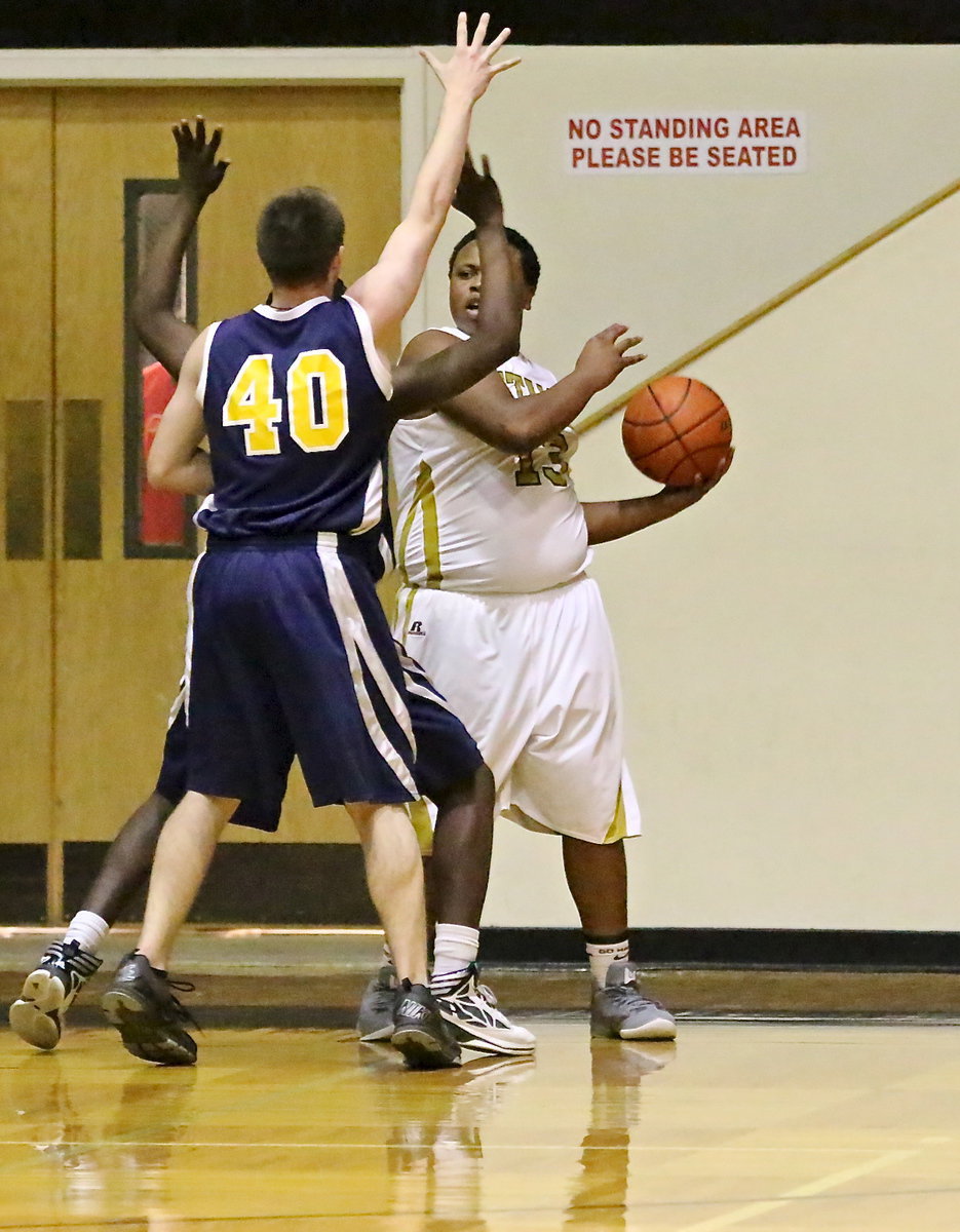 Image: Gladiator, Darol Mayberry(13) passes out of trouble with a pair of Eagles pecking at the ball.