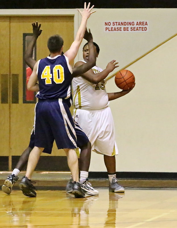 Image: Gladiator, Darol Mayberry(13) passes out of trouble with a pair of Eagles pecking at the ball.