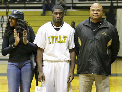 Image: Gladiator senior, TaMarcus Sheppard(10) is escorted by his mother, Lois Campbell, and his father, Coach Bobby Campbell.