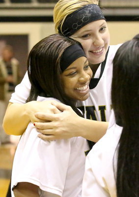 Image: Senior Lady Gladiator, Bernice Hailey receives a hug from junior Jaclynn Lewis during the Senior Night pre-game ceremony.