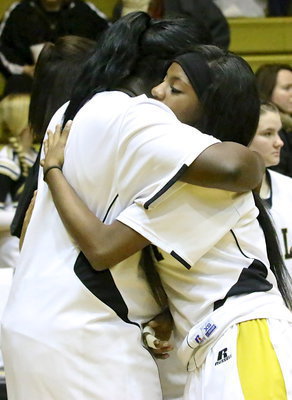 Image: Senior Lady Gladiator, Kendra Copeland receives a hug from teammate Taleyia Wilson during the Senior Night pre-game ceremony.