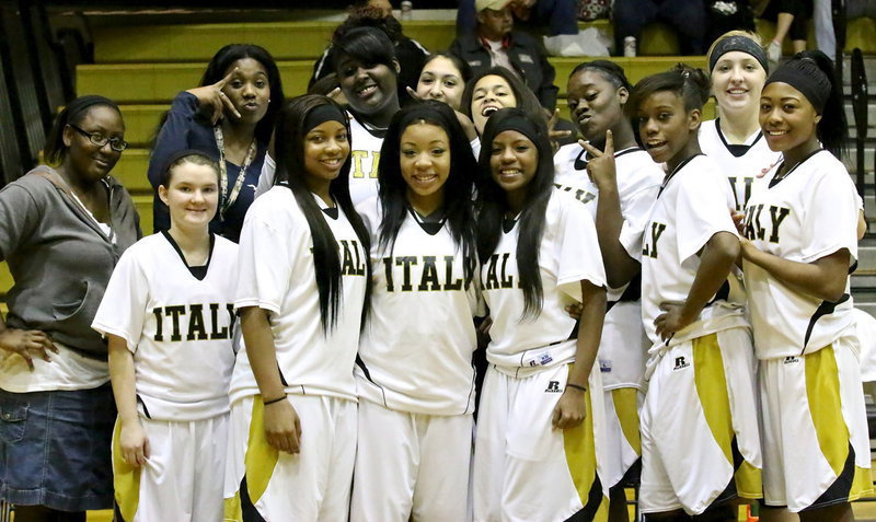 Image: Seniors, Bernice Hailey, Ryisha Copeland and Kendra Copeland are surrounded by love from their teammates before the start of their district game against Grand Prairie Advantage.