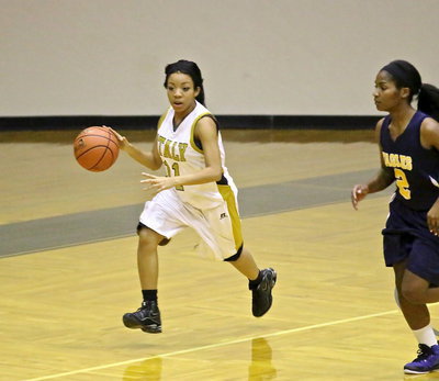 Image: Senior, Ryisha Copeland(11) pushes the ball up the court for the Lady Gladiators on her way to a 4-point night against Grand Prairie Advantage.