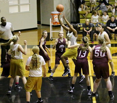 Image: Charisma Anderson(20) catches a rebound on the run and simultaneously puts it in for a score.
