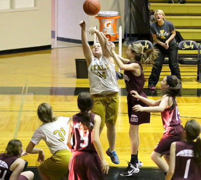 Image: Reagan Jones(34) draws a shooting foul from the low block as Coach Morgan Matthews cheers her on.