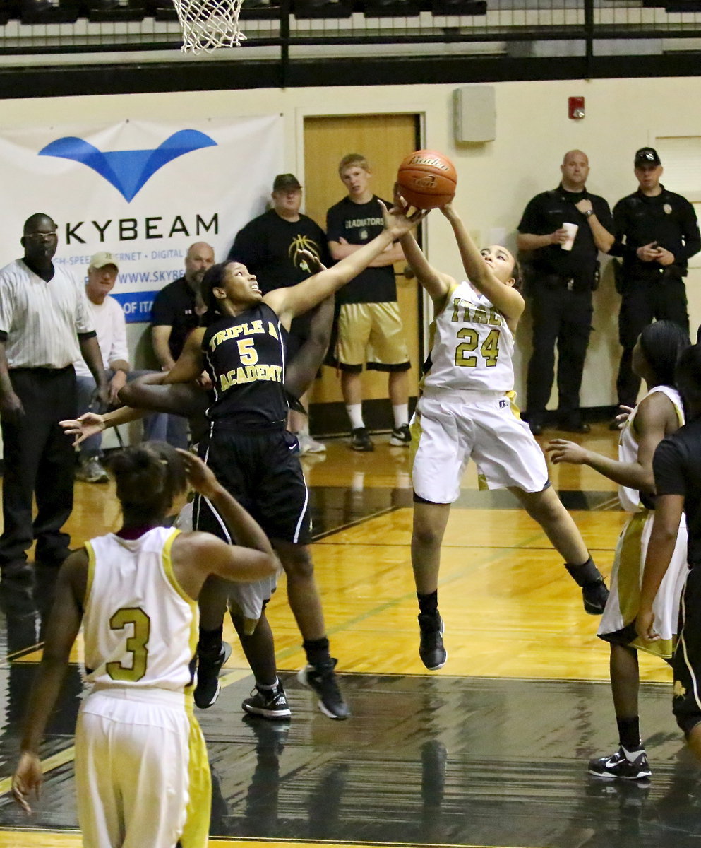 Image: Vanessa Cantu(24) grabs a rebound as Taleyia Wilson(22) stays locked onto a Lady Stallion.