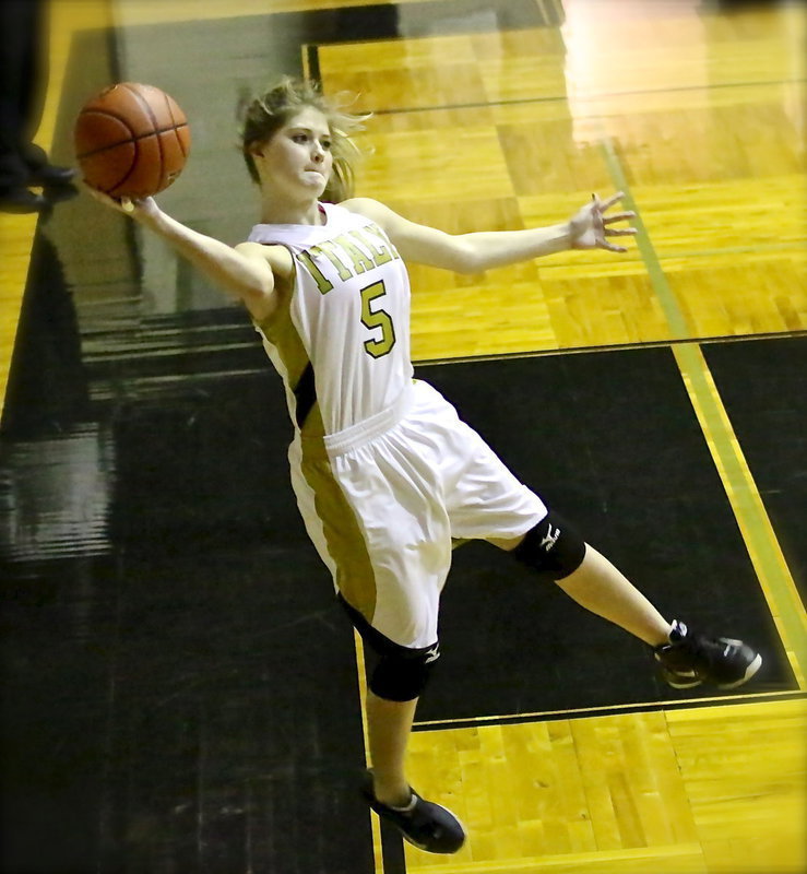 Image: Halee Turner(5) keeps the ball from going out of bounds.