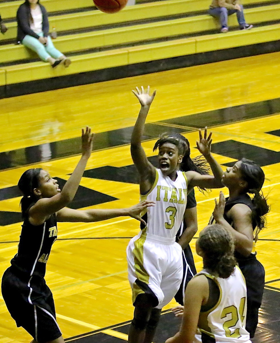 Image: Italy’s Kortnei Johnson(3) floats up a shot in traffic with teammate Vanessa Cantu(24) in rebounding position.