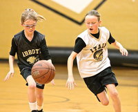 Image: IYAA star Gentry Rogers(4) dribbles past an Abbott defender on her way to 3-points during the 3rd/4th grade girls game that had to be decided in overtime.