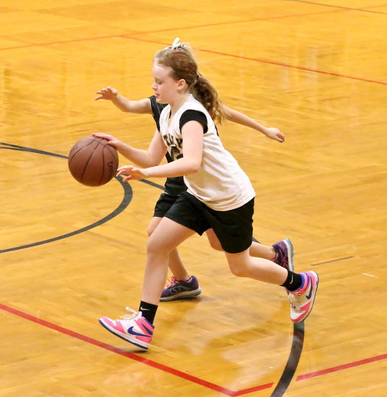 Image: IYAA’s Sadie Hinz(5) dribbles out of trouble to beat Abbott’s half-court press during the 3rd/4th grade girls game.