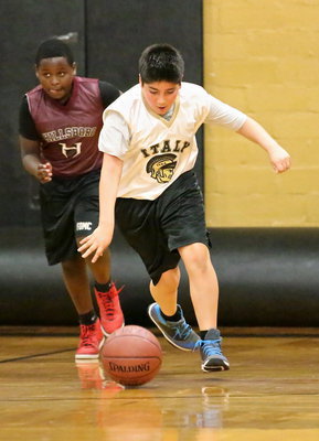 Image: Center, Andrew Celis(1) shows off his dribbling skills after grabbing a defensive rebound during the IYAA 5th/6th grade boys game against Hillsboro.
