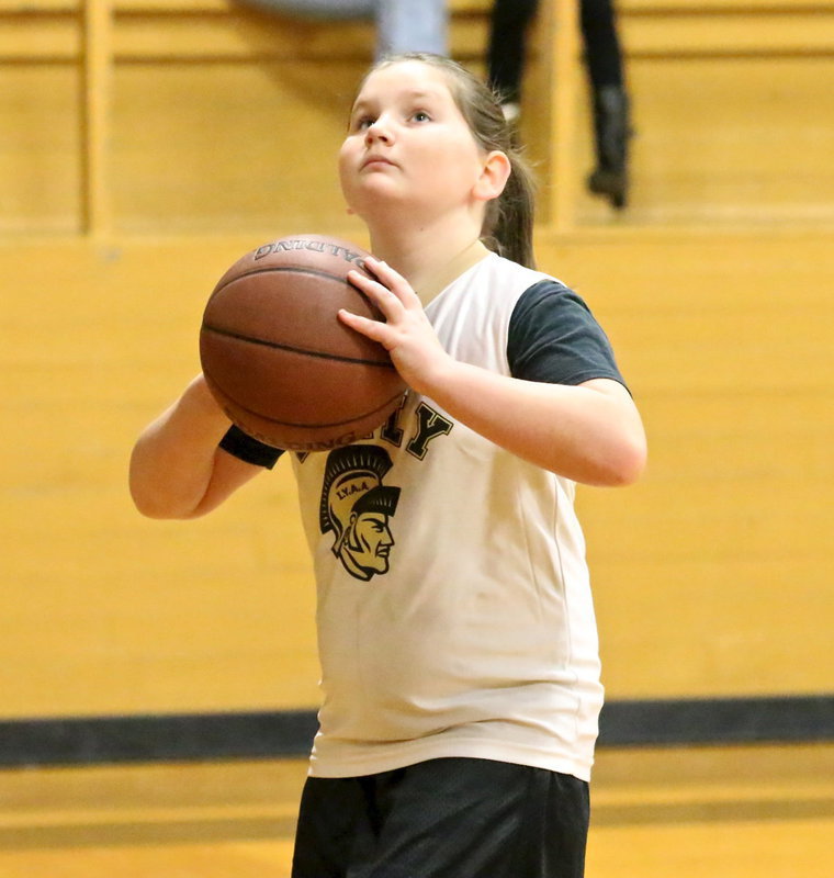 Image: IYAA’s Brianna Hall(7) concentrates during a pre-game layup before the 3rd/4th grade girls game.