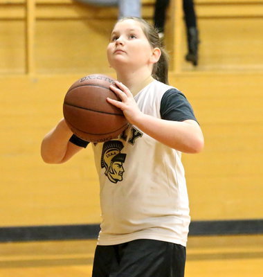 Image: IYAA’s Brianna Hall(7) concentrates during a pre-game layup before the 3rd/4th grade girls game.