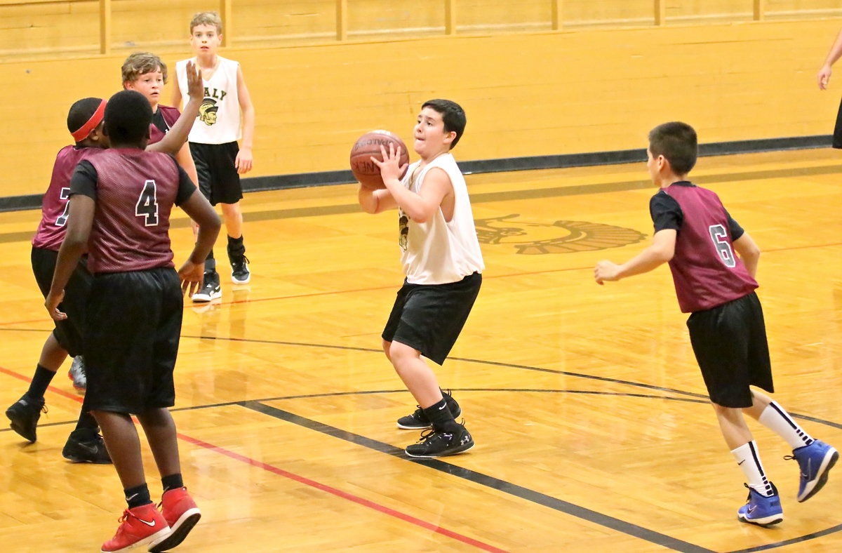 Image: IYAA’s Rocklin Ginnett(5) shoots a jumper from the top of the lane.