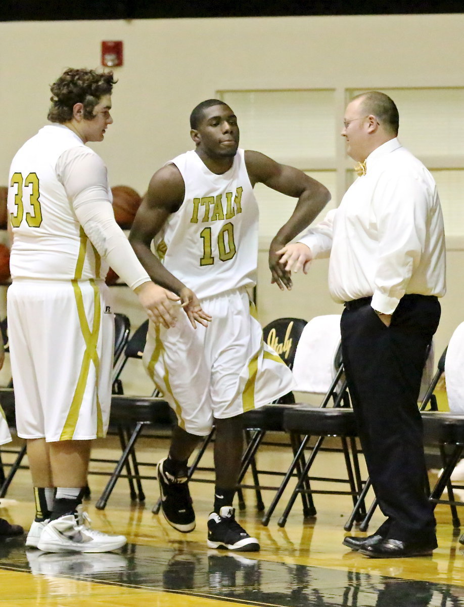 Image: Senior Gladiator Kevin Roldan(33) and Gladiator head coach Brandon Ganske slap fives with senior Gladiator TaMarcus Sheppard(10) who is without a doubt ready for Itasca.