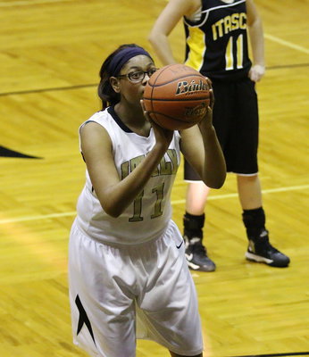 Image: JV Lady Gladiator Oleshia Anderson(11) attempts a charity shot.