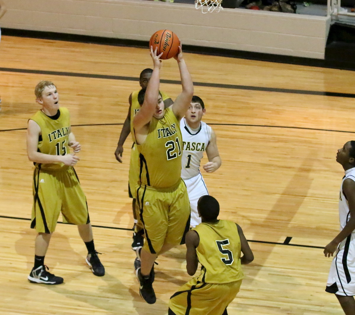 Image: Center Zain Byers(21) rips down a rebound for the Gladiators.