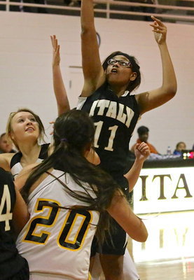Image: Center Oleshia Anderson(11) rises above the Itasca defense to put up a shot.
