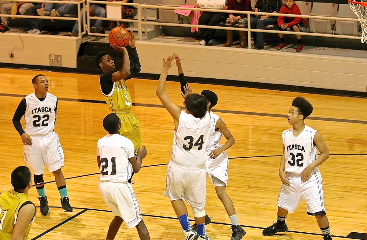 Image: Eric Carson(2) leaps into a jump shot.