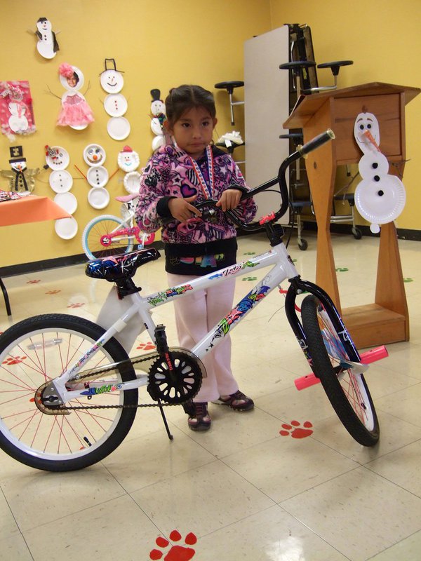 Image: Alician Luna (Pre-K student) won a bike for perfect attendance.