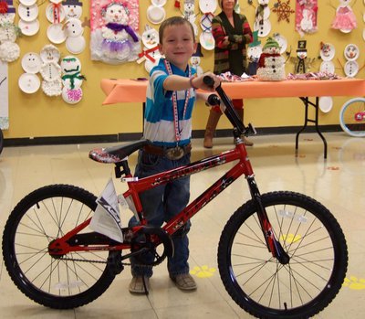 Image: Braden Sigler (1st grader) is the happy winner of a snazzy bike for perfect attendance.