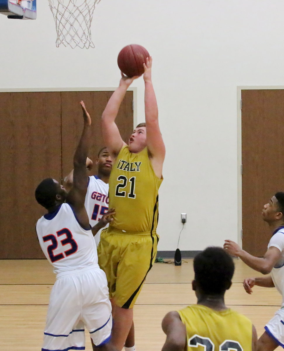 Image: Zain Byers(21) out duels a couple of Gator defenders to bank in a shot.