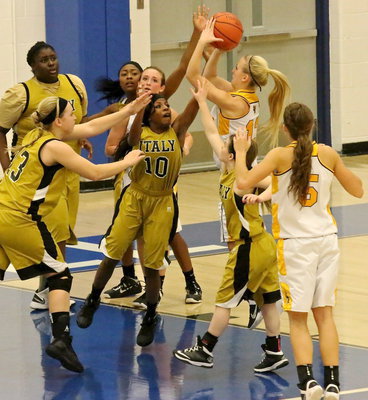Image: Lady Gladiator defenders Kendra Copeland(10), Jaclynn Lewis(13) and Tara Wallis(4) pressure an Era shooter as teammates Cory Chance(40) and K’Breona Davis(12) position for the rebound.