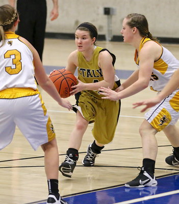Image: Lady Gladiator guard Tara Wallis(4) draws   the attention of a couple of Lady Hornets.