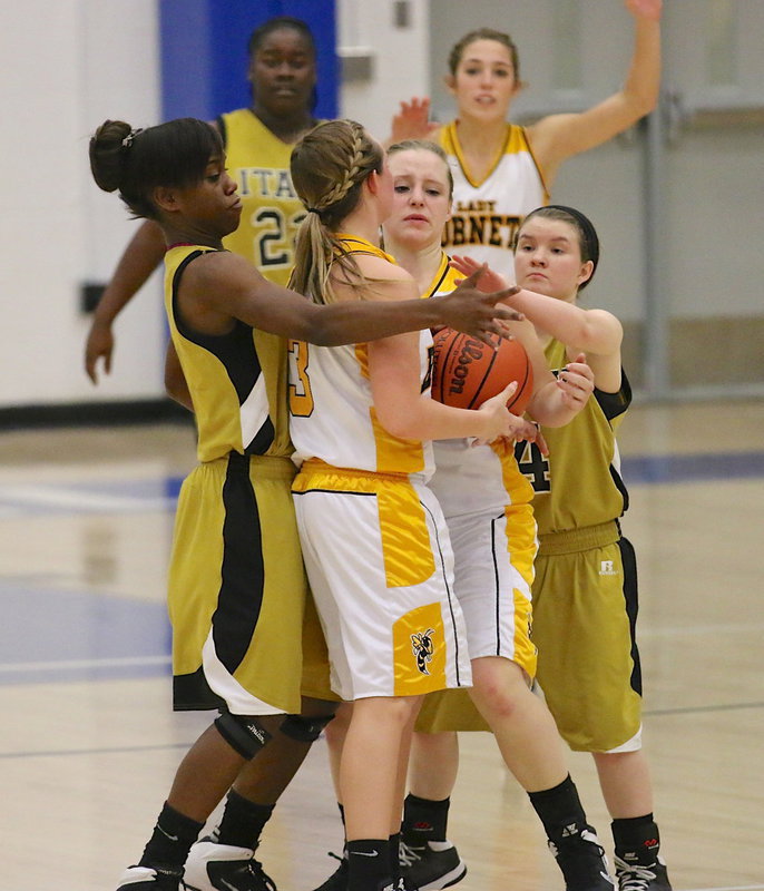 Image: Defensively, Kortnei Johnson(3), Tara Wallis(4) and their Lady Gladiator teammates tried to put the clamps on the Lady Hornets in the second-half but Era held on for the bi-district win, 50-42.