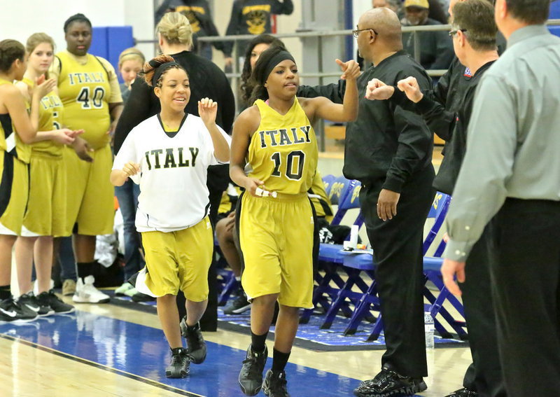 Image: The Copeland sisters, Kendra Copeland(10) and Ryisha Copeland(11), trot out along with their teammates during the pre-game introductions.