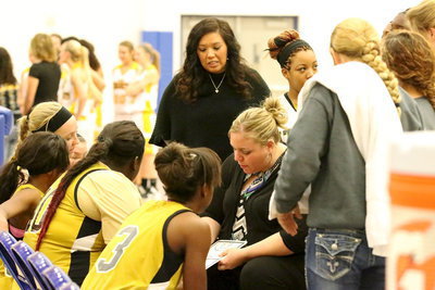 Image: Lady Gladiator coaches Melissa Fullmer and Tina Richards talk strategy with their team during a timeout.