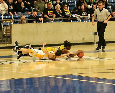 Image: Lady Gladiator Kortnei Johnson(3) wins the battle for the loose ball with Era getting called for holding.