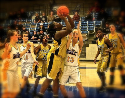 Image: Lady Gladiator Taleyia Wilson(22) secures an offensive rebound and then draws a shooting foul on the put back.